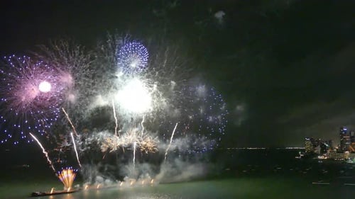 Brilliant Fireworks Exploding Over the Water at Night