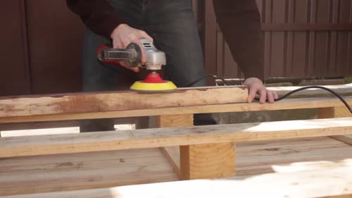 Man Sanding Wood Pallet with Sanding Machine