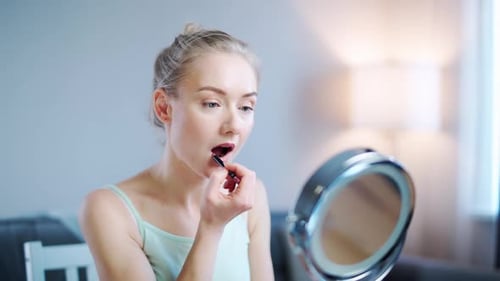 Young Woman Beauty Blogger Shows How to Paint your Lips and Apply Makeup Makes a Stream on Social