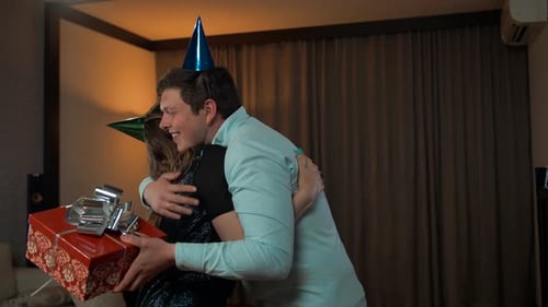 Man Receives Birthday Gifts from Friends at Home