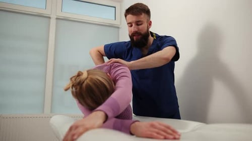 Bearded Chiropractor Treating Patient in Office