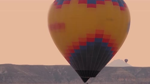 Hot Air Balloons at Sunrise Over Desert Landscape