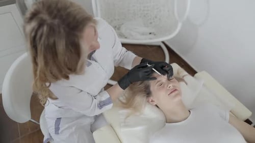 Woman Receives Forehead Injection in Medical Office