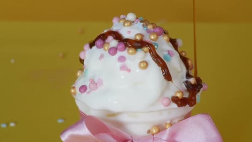 Ice Cream Is Poured with Caramel in a Pastry Shop. Dessert Decoration. Close-up.
