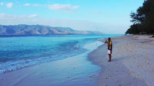 Fishing Happy guy on holiday spends quality time at beach on summer white sand and blue background 4