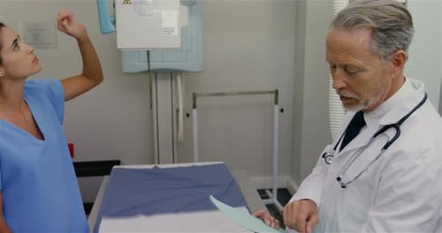 Doctor Consulting with Patient in Hospital X-Ray Room