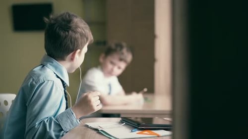 Boy Talks During Schooling With Earbuds