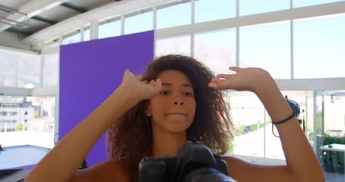 Model holding camera in photo studio 4k