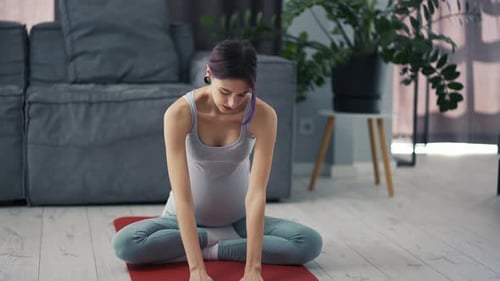 Pregnant Woman Does Smooth and Gentle Yoga Stretching Exercises