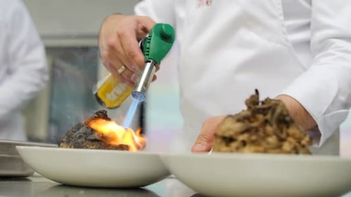 Chef Torching Food for Plating in Restaurant Kitchen
