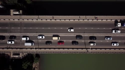 Drone's Eye View Aerial Top Down View Of Traffic Driving Over A Modern Bridge