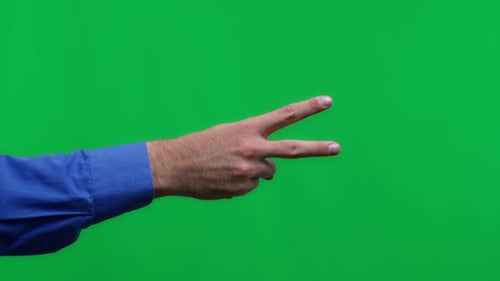 Human Hand on a Green Background Isolate the Person Shows Two Fingers