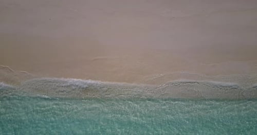 Luxury fly over tourism shot of a summer white paradise sand beach and blue water background in high