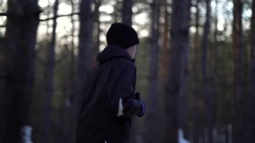 Child Runs Through Snowy Winter Forest