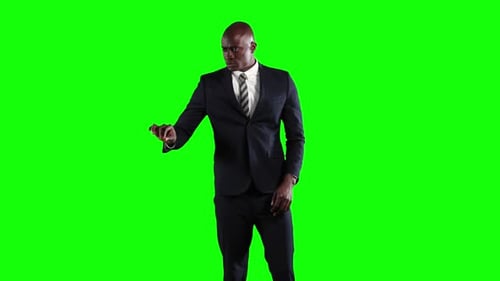 an African American man in suit in green background