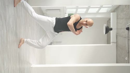 Slow Motion of Man Performing Elements of Modern Dance in a Bright Studio