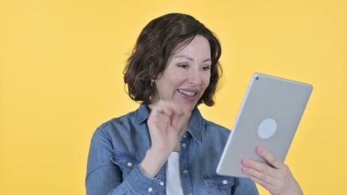 Mature Woman Waving During a Video Call