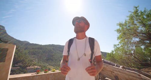 Man Enjoys Tropical Mountain View on Sunny Day