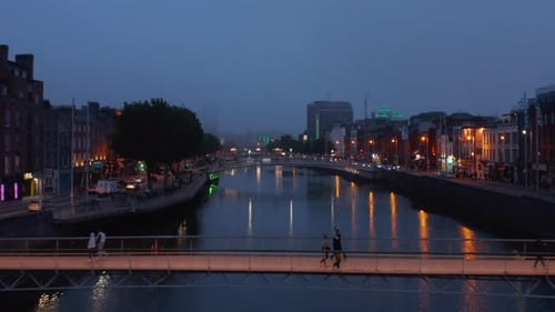 Fly Over Footbridges Across Liffey River in City Centre in Evening