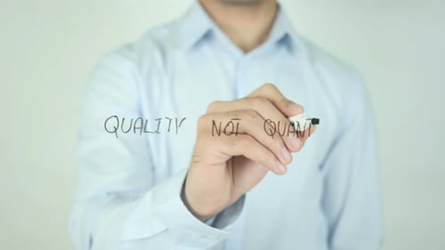 Man Writes Words Quality Not Quantity with Marker