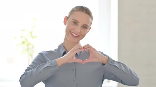 Blonde Woman Makes Heart Shape With Hands