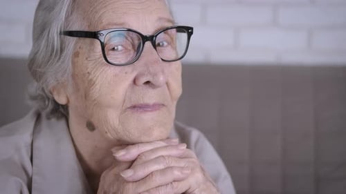 Senior Woman Resting Chin on Hands Indoors
