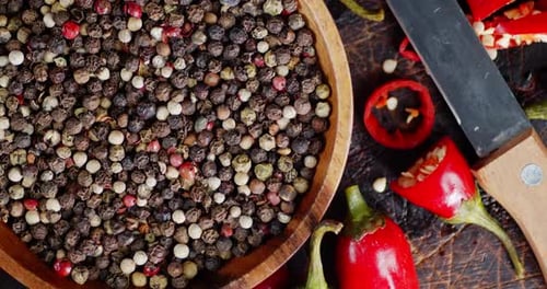 Vibrant Peppercorns and Chili Peppers with Knife