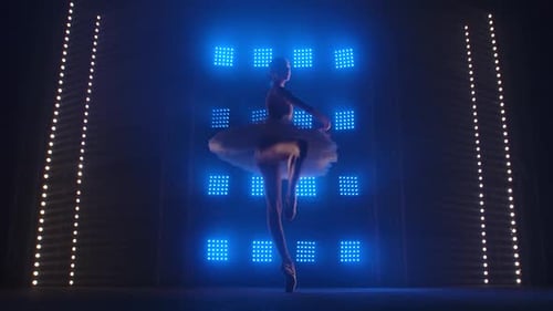 Ballerina Performs Ballet on Stage with Blue Lights