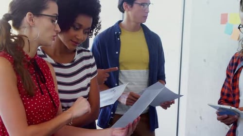 Team Collaborating in Modern Workplace Discussing Project