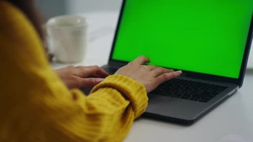 Closeup Business Woman Hands Working on Laptop Computer with Green Screen.