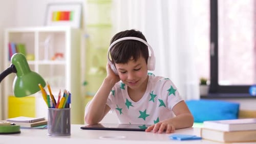 Little Boy with Tablet Pc and Headphones at Home 31