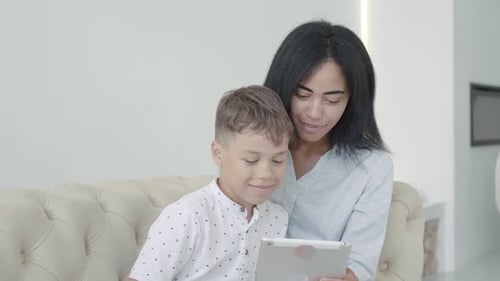 Mother and Son Using Tablet Together at Home