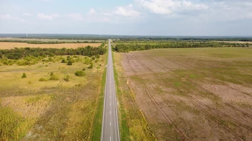 a Highway Stretching to the Horizon Among Agricultural Fields