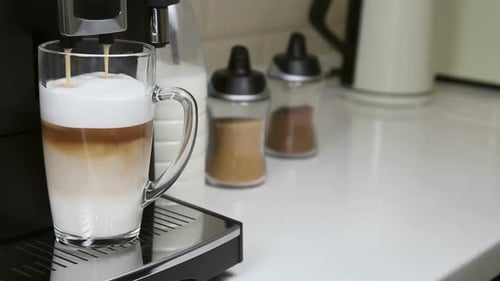 Delicious Coffee Pouring Into a Glass Mug