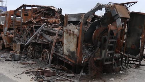 Burnt military vehicles of Russian soldiers on the bridge across the river.