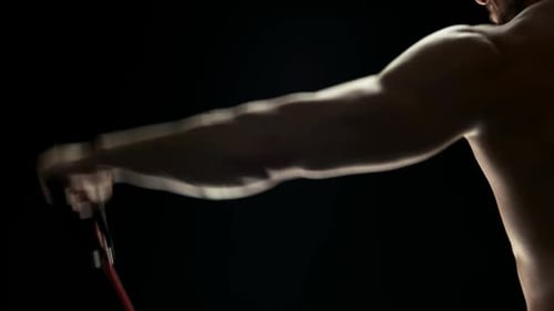 Bodybuilder Doing Resistance Band Exercises.