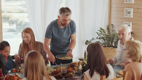 Family Gathering around Festive Dinner Table