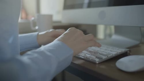 Hands Typing on Silver Computer Keyboard