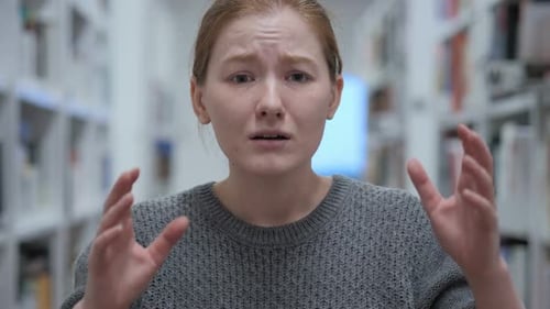 Student Talking and Presenting in the Library