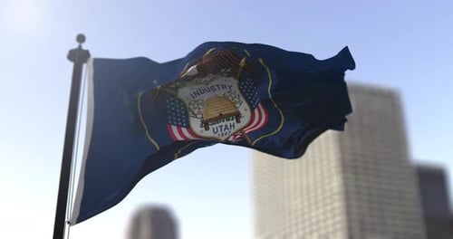 Utah State Flag Waving in the Wind with City Background
