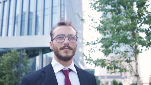 Young Adult Man Using Mobile Phone Outside Office