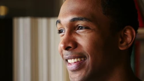 Young Man Laughing and Smiling Indoors, Close-Up