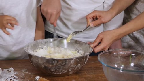 Family Mixing Baking Dough in Bowl