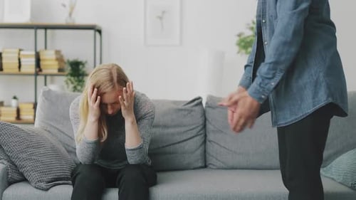 Sad Woman on Couch, Man Arguing
