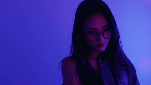 Studio Portrait of Asian Woman with Neon Lights.