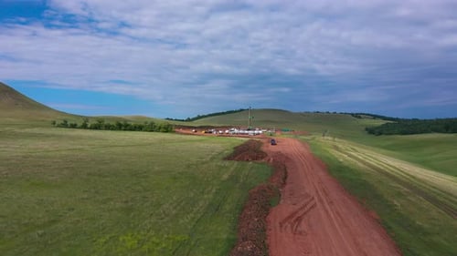 Oil and Gas a Land Rig Onshore Drilling Rig in the Middle of a Rice Field Aerial View From a Drone