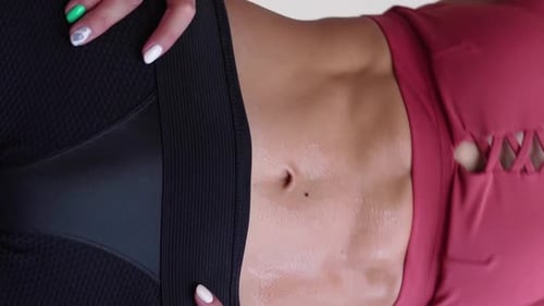 Sweaty Toned Woman's Midsection After Workout