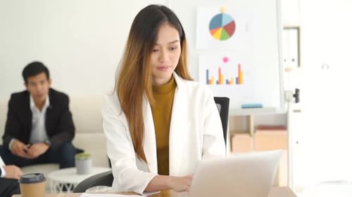 Woman Works at Laptop in Modern Office