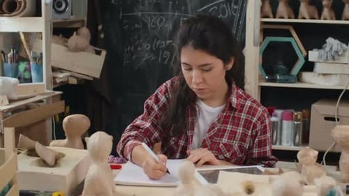 Young Woman Drawing at Art Studio Table