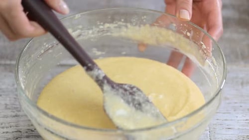 Girl Stirring Batter for Cake. Close-up.